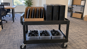 Retired laptops and desktop computers arranged on an equipment cart